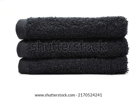 Makeup remover towel stacked black bathroom towels isolated on a white background Royalty-Free Stock Photo #2170524241