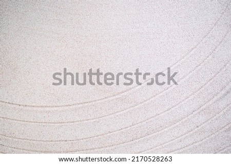 Texture line Japanese pattern on white sand background. buddhism texture wave on desert nature at coast of shore. top view line abstract on beach with stone. Purity Meditation calm or lifestyles spa.  Royalty-Free Stock Photo #2170528263