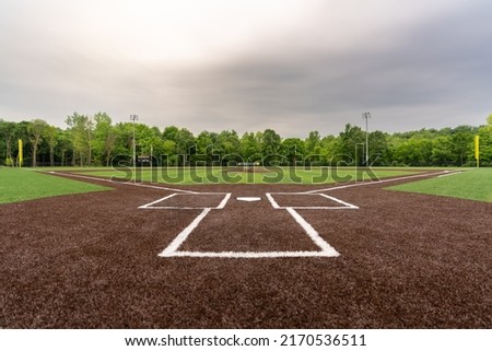 View of  high school synthetic turf baseball field looking from batters box toward the outfield. Royalty-Free Stock Photo #2170536511