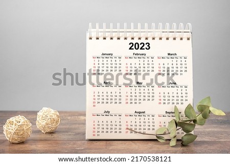 Calendar Year 2023 schedule. 2023 desk calender notepad on wooden table and gray background. New Year. plans for 2023. gray background Royalty-Free Stock Photo #2170538121