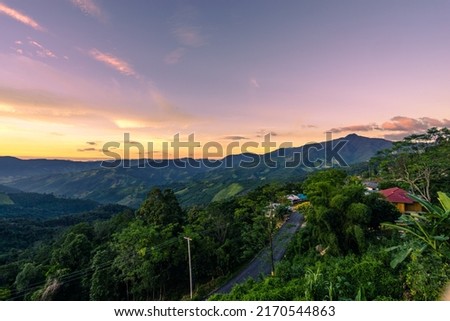 Beautiful sunset scenic with light shade into the mountain which locates in rural countryside at Doi Sakad, Pua, Nan, Thailand Royalty-Free Stock Photo #2170544863