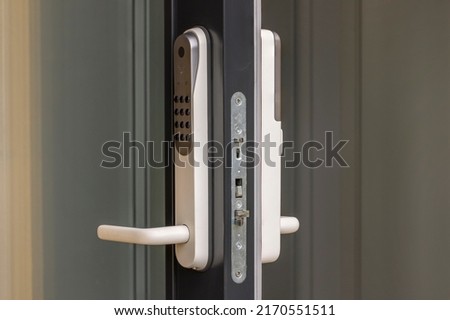 Close up view at open entrance door with modern white digital lock isolated.  Royalty-Free Stock Photo #2170551511