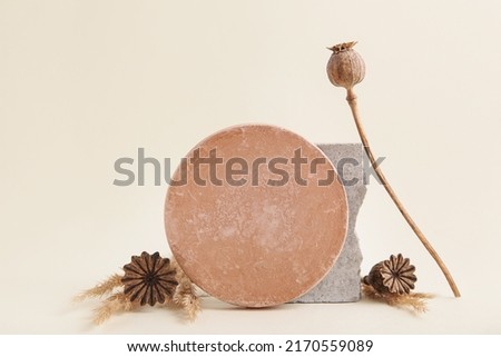 Minimalist monochrome still life. Abstract nature scene composition of stones, Dried Poppy Seed. Neutral beige background for cosmetic, identity, packaging. Royalty-Free Stock Photo #2170559089