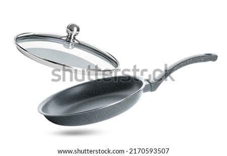 New frying pan and glass lid on white background Royalty-Free Stock Photo #2170593507