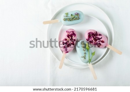 Ice cream bars with pink and green topping, selective focus image