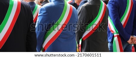 many elegant Italian mayors with elegant dress during the official ceremony with the tricolor green white and red stripe Royalty-Free Stock Photo #2170601511