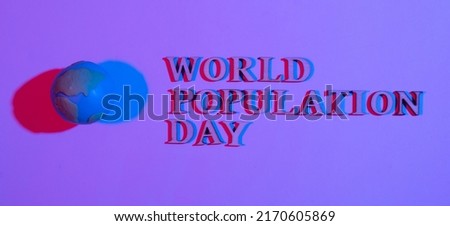 World population day write by wooden letter with globe in neon light.