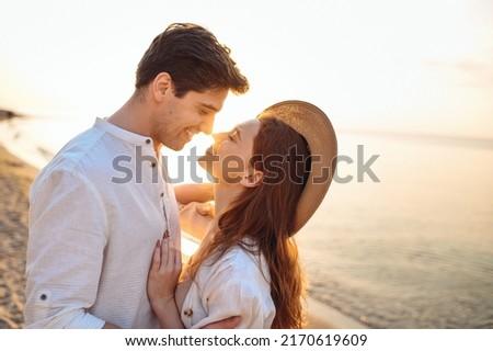 Close up profile young happy couple two friends family man woman in white clothes hug touch noses going to kiss together at sunrise over sea beach ocean outdoor seaside in summer day sunset evening. Royalty-Free Stock Photo #2170619609