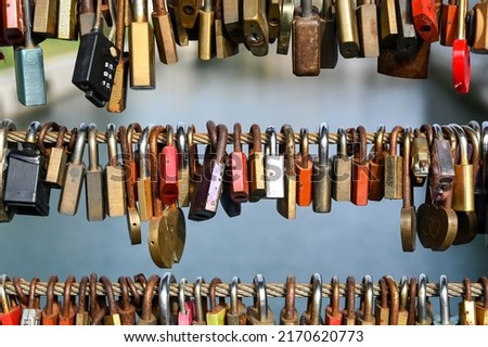 Symbol of love. Padlocks attached to a bridge. Romantic Locks symbolizing love forever on the steel fence. Locked padlocks symbolize unbreakable love.