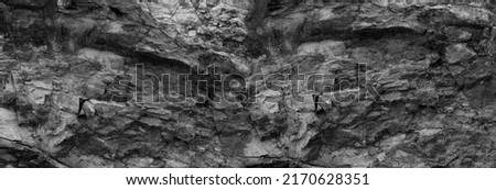 natural rock background. brown gray stone texture. Black grunge background. Mountain close-up. Distressed backdrop.