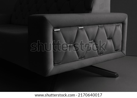 dark handmade sofa made of eco-leather in the interior of the house