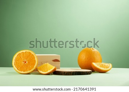 A front view of lemon decorated with transparent podium in green background  Royalty-Free Stock Photo #2170641391