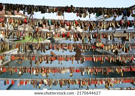 Symbol of love. Padlocks attached to a bridge. Romantic Locks symbolizing love forever on the steel fence. Locked padlocks symbolize unbreakable love.