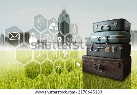 Virtual application float over field with travel bag beside and city background, Technology concept