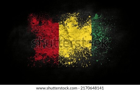 brush painted flag of Guinea isolated on black background