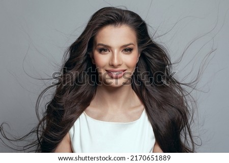 Gorgeous beautiful fashion model woman with makeup and long blowing hair with wind on white background portrait Royalty-Free Stock Photo #2170651889