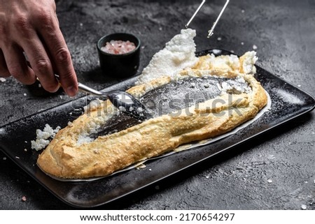 Fish covered in meringue salt. Tray with fish and lemon. Breaded river trout fish. New recipe of delicious fish. still life. top view. Healthy food.