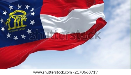 The state flag of Georgia waving in the wind. Georgia is a state in the Southeastern region of the United States. Democracy and independence. Royalty-Free Stock Photo #2170668719