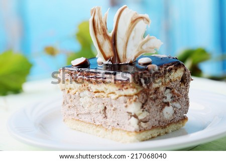 Piece of cake with cream and chocolate icing