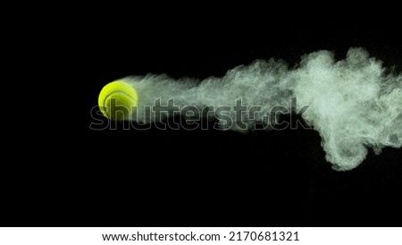Freeze Motion Shot of Flying Tenis Ball Containing Light Green Powder Royalty-Free Stock Photo #2170681321