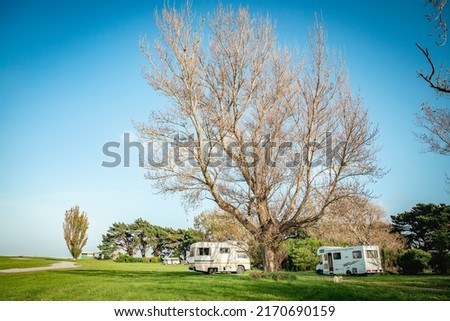 motorhome on a camping ground, caravan vacations, campervan trip. High quality photo