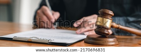 Lawyer man holding pen with contract or agreement document to the customer for signing in courtroom legal, Sign a contract business. Royalty-Free Stock Photo #2170696831
