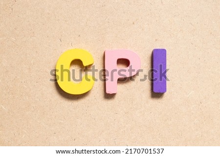 Color alphabet letter in word CPI (abbreviation of Consumer Price Index) on wood background