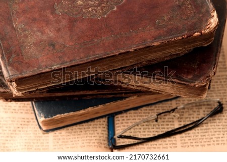 Old worn shabby leather-bound jewish books on open blurred Torah in the background. Closeup. Selective focus Royalty-Free Stock Photo #2170732661