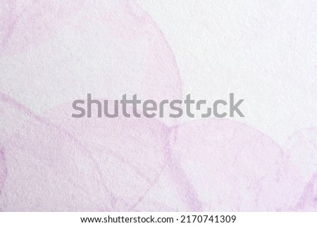 Pink geometric background, textured paper painted with pastel colored circles. Abstract monochromatic composition with copy space.