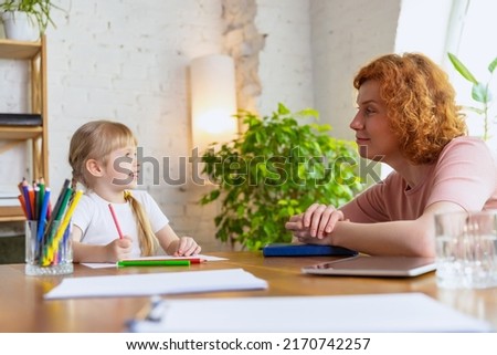 Individual lesson in center of early development of children. Professional female therapist communicate with child during extracurricular activities. Concept of support, studying, childhood, emotions Royalty-Free Stock Photo #2170742257