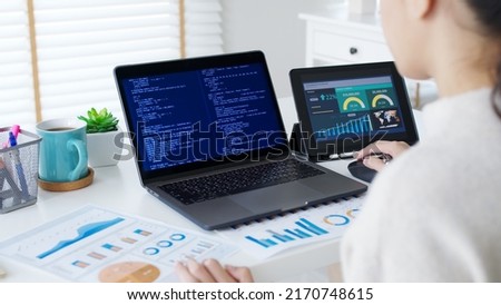 Back rear view of young asian woman, freelance data scientist work remotely at home coding programming on Big data mining, AI data engineering, IT Technician Works on Artificial Intelligence Project. Royalty-Free Stock Photo #2170748615