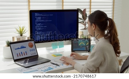 Asia young business woman sit busy at home office desk work code on desktop PC reskill upskill for job career remote self test IT deep tech ai design skill online html text for cyber security. Royalty-Free Stock Photo #2170748617