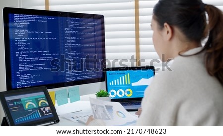 Asia young business woman sit busy at home office desk work code on desktop reskill upskill for job career remote self test IT deep tech ai design skill online html text for cyber security workforce. Royalty-Free Stock Photo #2170748623