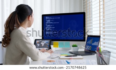 Asia young business woman sit busy at home office desk work code on desktop reskill upskill for job career remote self test IT deep tech ai design skill online html text for cyber security workforce. Royalty-Free Stock Photo #2170748625
