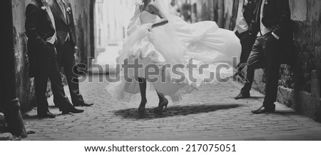 Happy bride dancing around boys. Wedding day  Royalty-Free Stock Photo #217075051