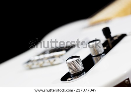 white electric guitar on black