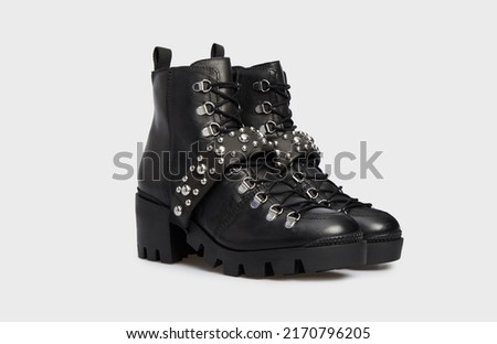 Women's fashion combat boots isolated on white background. Female classic spring autumn shoes. Leather laced casual footwear with metal rivets, spikes, buckle, heel. Punk, emo, grunge, goth style