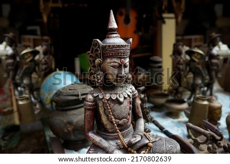 traditional wooden ascetic statue smiling at the art market