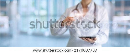 Doctor presenter shows health care system on virtual computer screen.