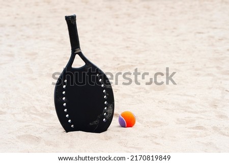 Racket and ball on the sandy beach. Summer sport concept. Horizontal sport theme poster, greeting cards, headers, website and app Royalty-Free Stock Photo #2170819849