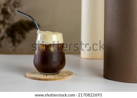 Iced coffee. Coffee cold brew drink cocktail with ice cube and straw on abstract background. Summer refreshing drink concept. Royalty-Free Stock Photo #2170822695