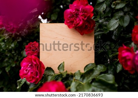 
Background, inscription, signboard, cover, card. Wooden background with a place for an inscription in a frame of beautiful red roses.