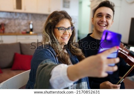 Couple woman and man caucasian relaxing smiling at home and taking photos Modern lifestyle cozy home relaxing concept