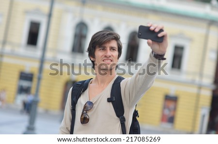 Student / tourist taking self portrait in the europe street