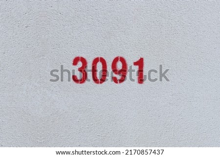 Red Number 3091 on the white wall. Spray paint.
