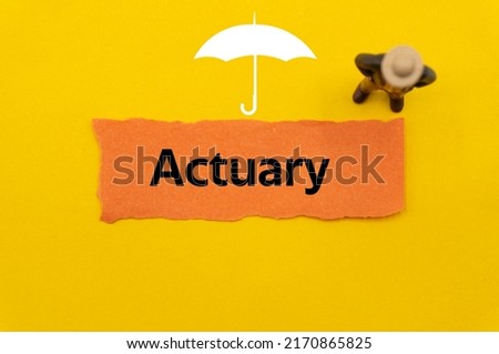 Actuary.The word is written on a slip of colored paper. Insurance terms, health care words, Life insurance terminology. business Buzzwords. Royalty-Free Stock Photo #2170865825