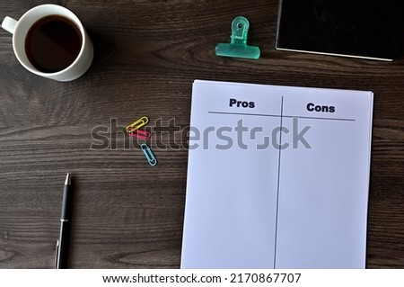 There is dummy documents that created for the photo shoot on the desk about Pros Cons.