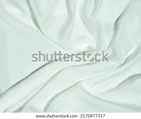 White cloth curve. texture of silk, satin. Shiny fabric background and copy space.