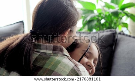 The little daughter hugs her mother tightly. Kiss and hug the happy family. Happy mother's day.