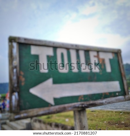 defocused abstract background of signboard with directions to the toilet